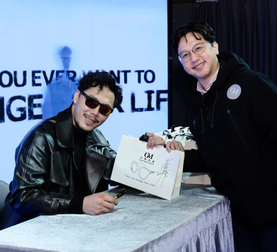 Celebrity signing autograph at brand launch event